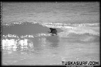 Tubing surf and surfing photos of waves in Black and white